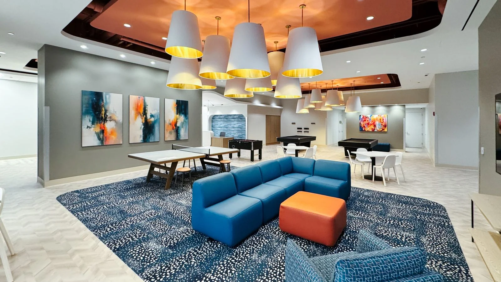 Shared lounge with seating and game tables at the Chicago student residence